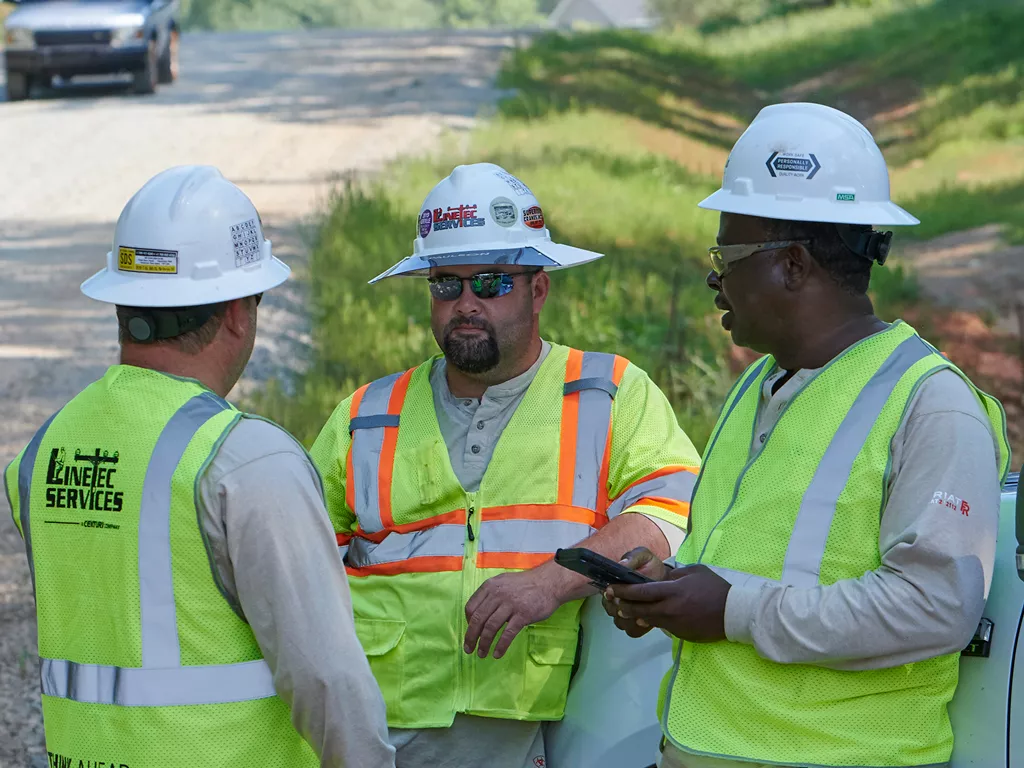 A group of Linetec workers discuss a project.