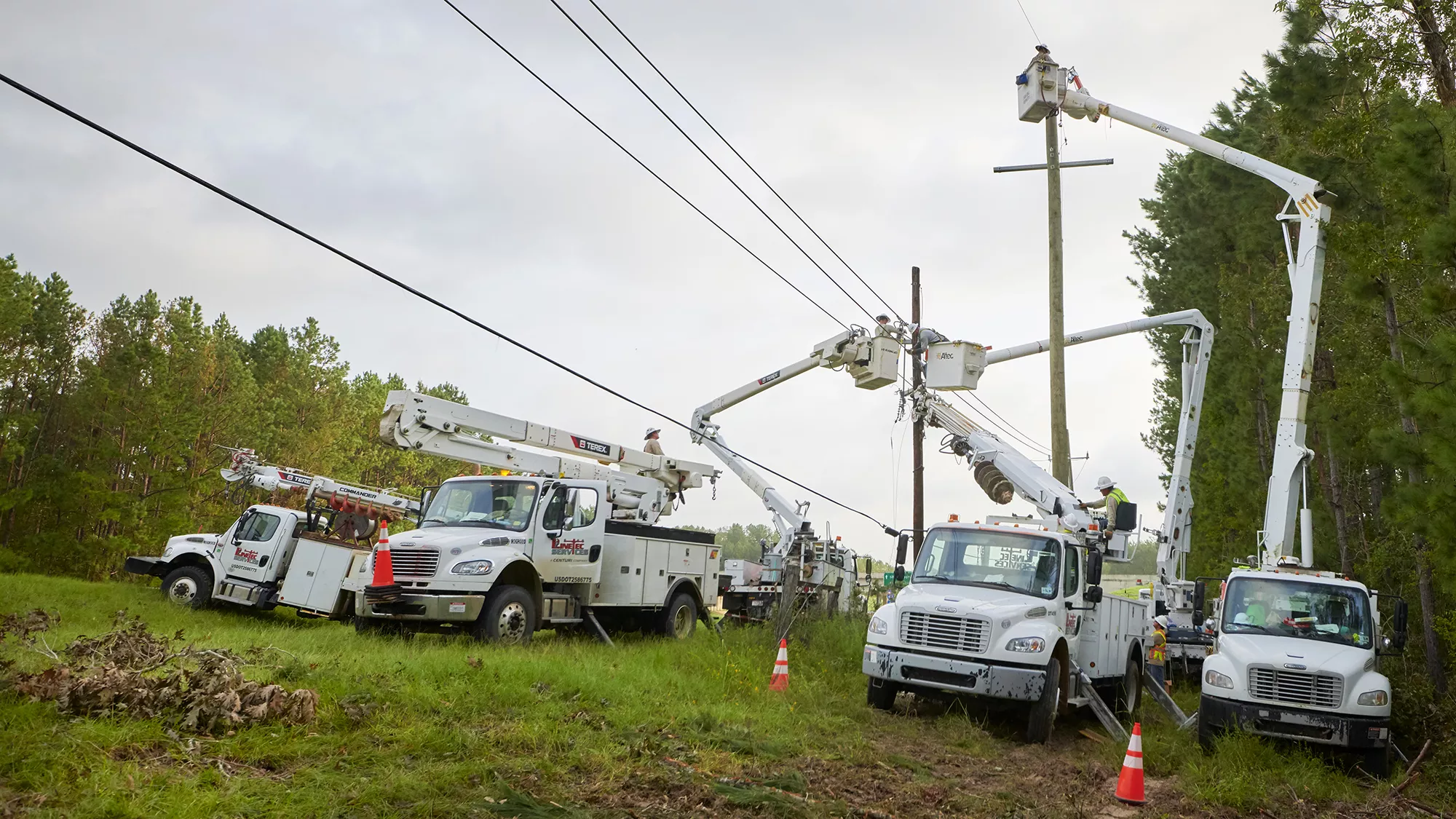 A Linetec team in trucks work on power lines.