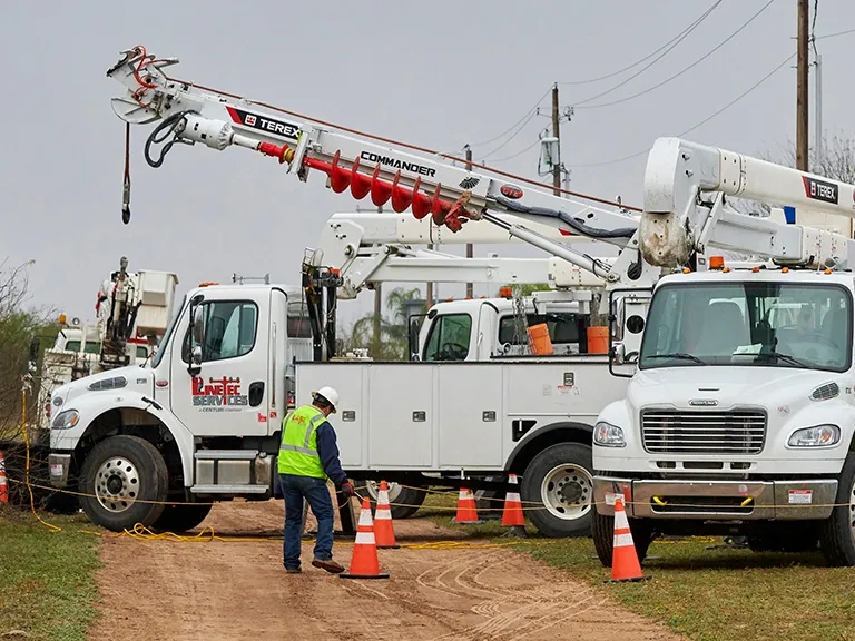 A Linetec worker places cones in front of trucks in Laredo,Texas.